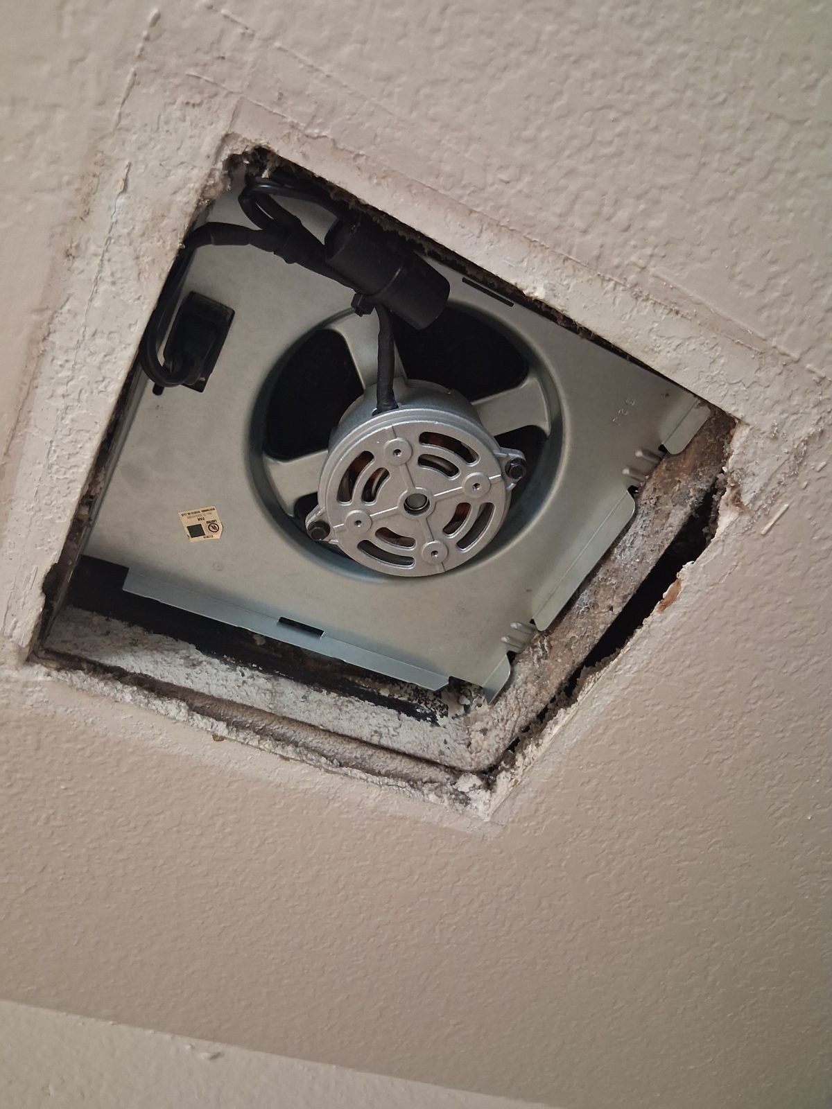 New exhaust fan housing set in the ceiling opening