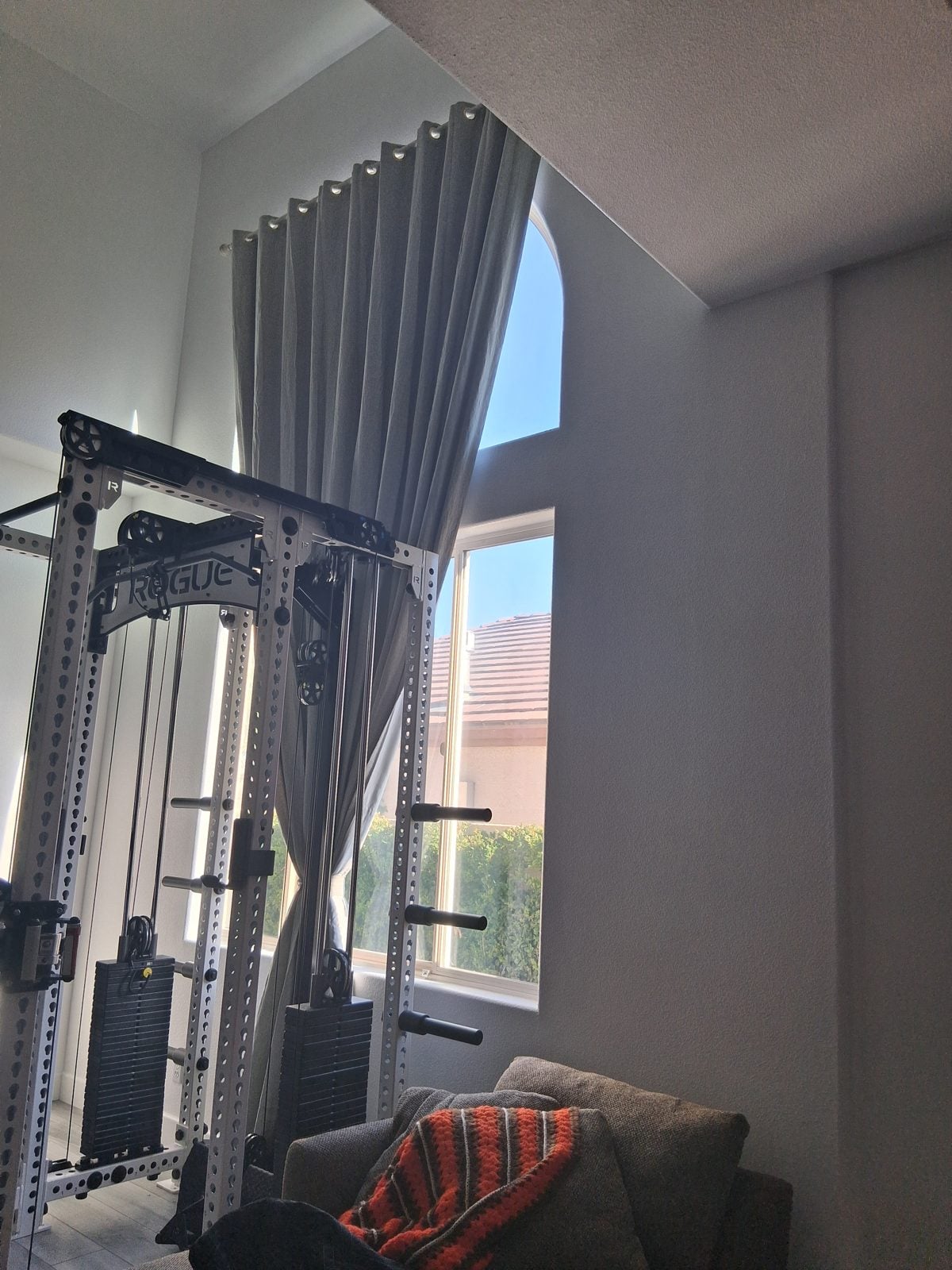 Home gym rack assembled next to a tall window