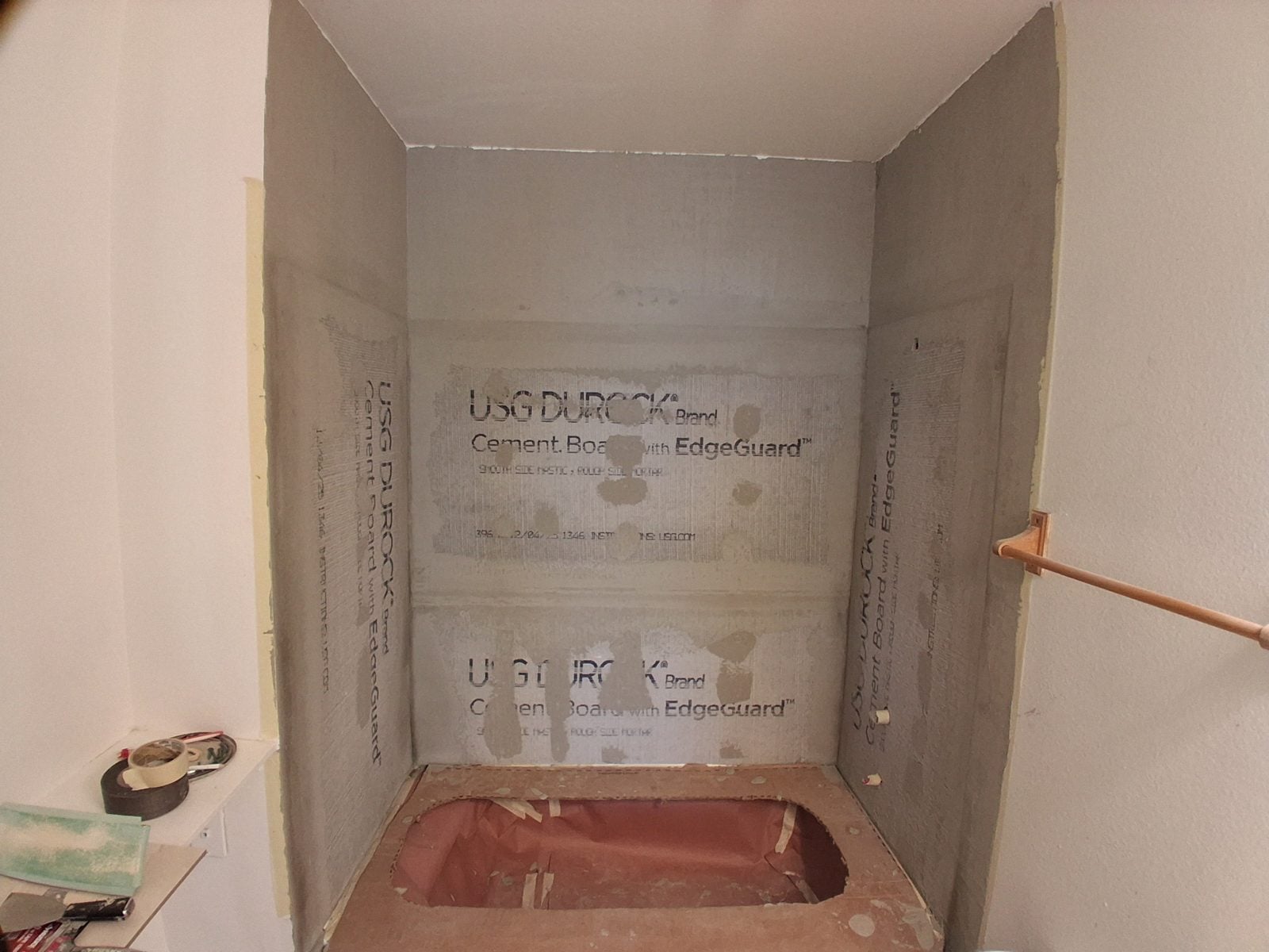 Shower stripped to new cement board walls before tile